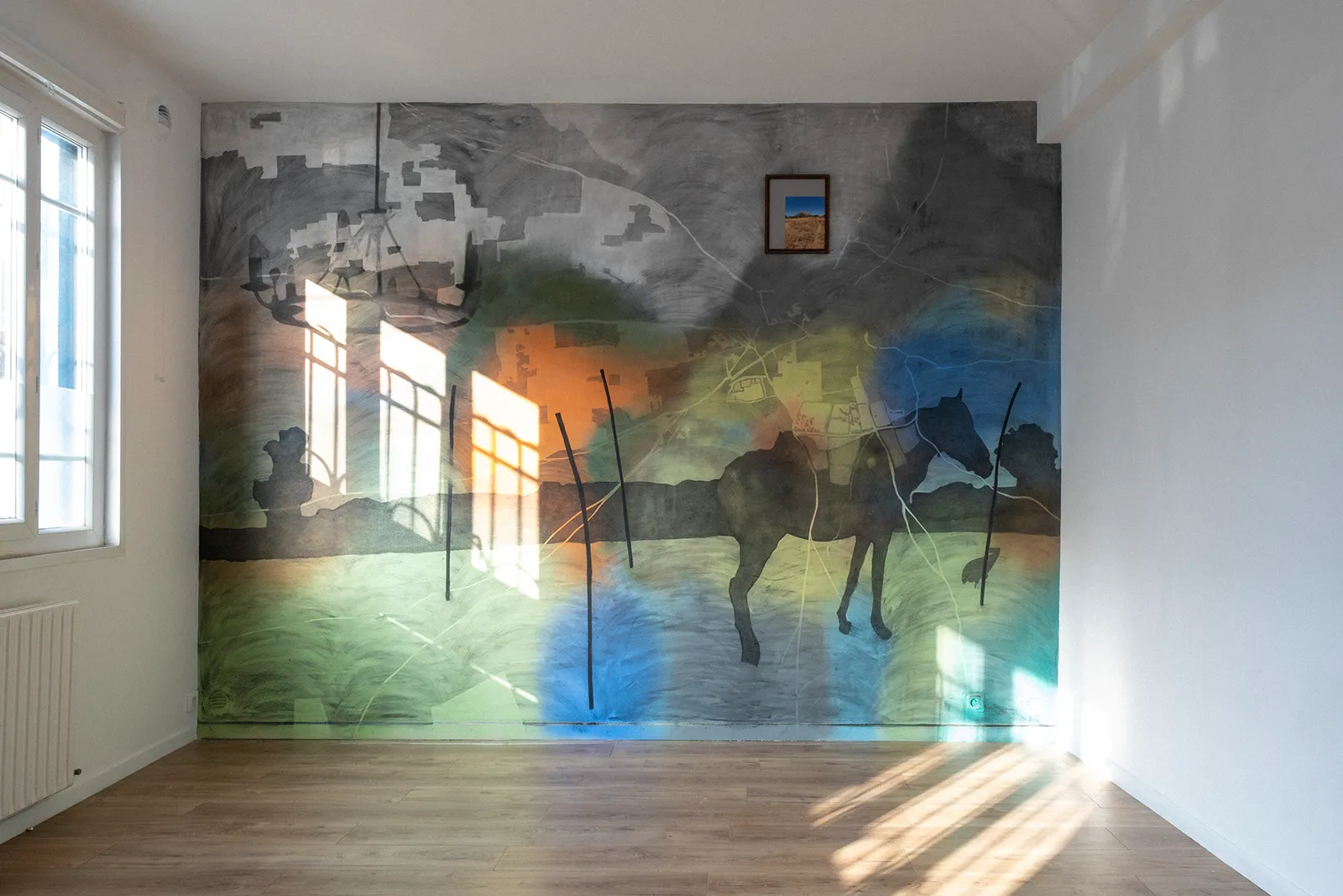 Large mural from the Reconnecting series, combining abstract landscapes, architectural fragments, animal silhouettes, coloured fields, and a small framed photographic insert.