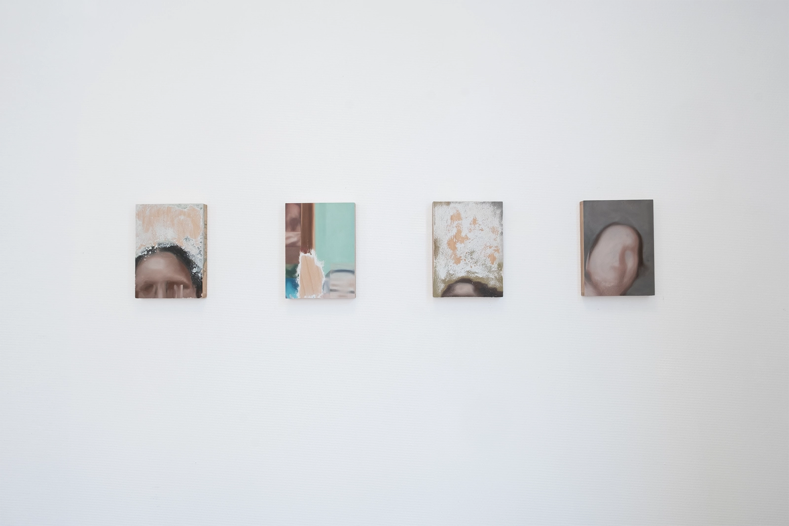 Aniruddha Biswas, Still Connecting, 2026, installation view of small oil paintings on wood made from blurred video-call screenshots and partially erased with acetone.