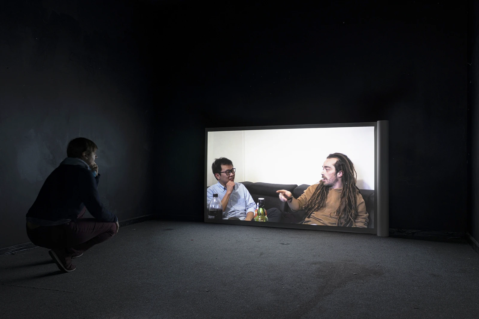 Aniruddha Biswas, Antakshari, 2021, video installation showing a spectator watching the video installation