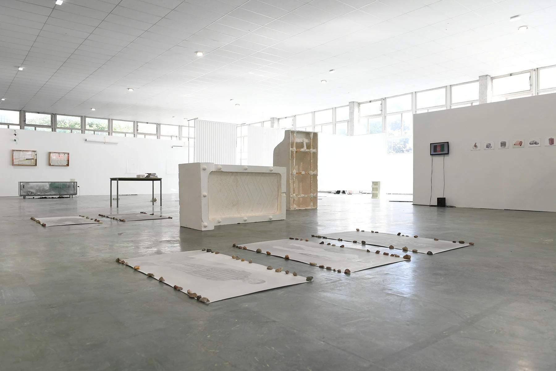 Aniruddha Biswas, La courbe, 2022, installation view of a plaster mould of a curved mattress placed in an exhibition space.